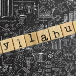 Chalkboard with doodles and letter blocks that spell syllabus