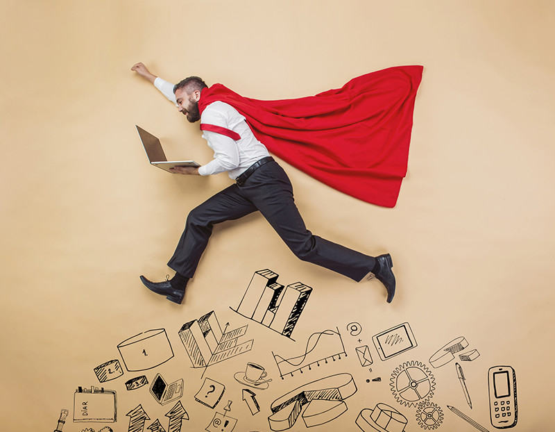 Man in superhero cape holds computer while jumping over doodles of school related images for Force Multipliers in the Classroom