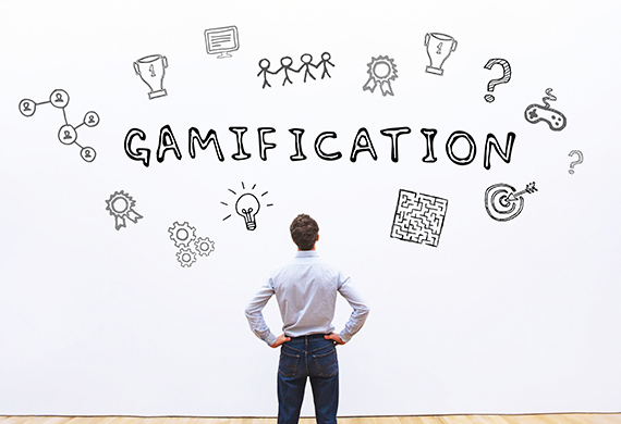 Person looks above him, where icons of games an the word "gamification" is hovering