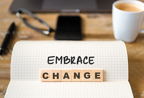 Piece of paper says the words, "Embrace change"