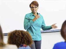 Instructor teaches in front of classroom