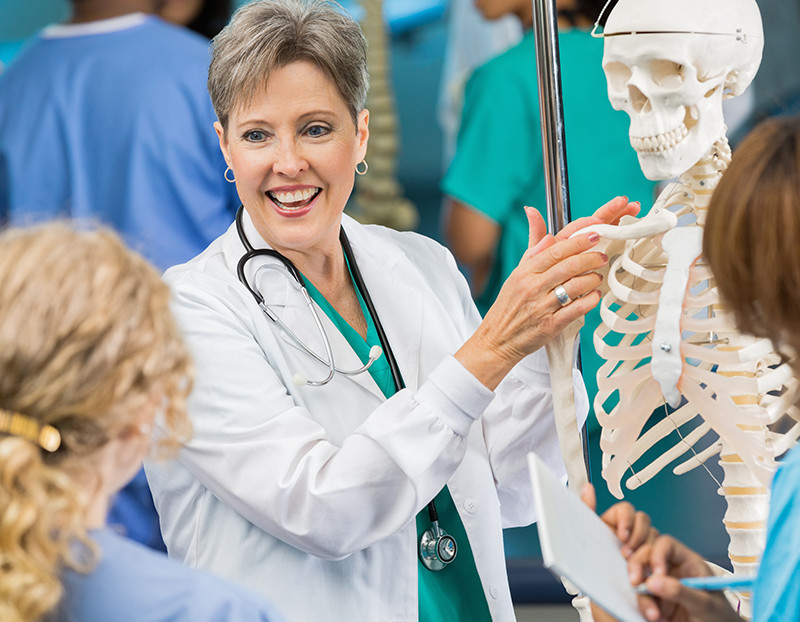 Doctor displays fake skeleton to nursing students