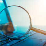 magnifying-glass-looking-at-computer-screen