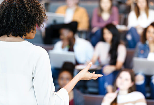 teacher-in-front-of-large-class-presenting