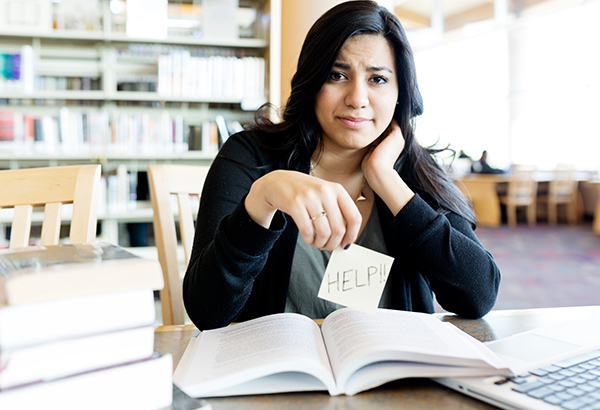 student-studying-holding-up-sign-for-help