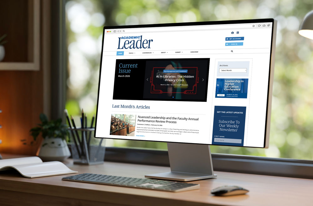 a desktop computer in an office displays the Academic Leader website homepage