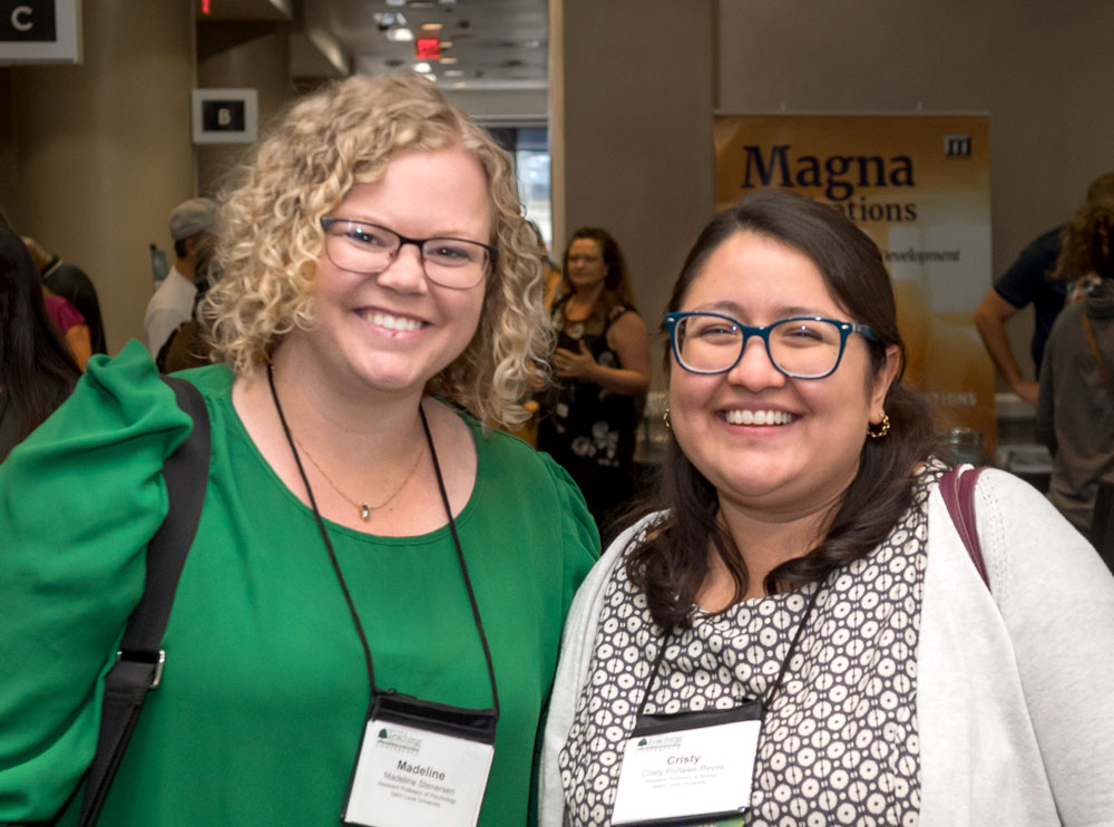two smiling women pose for a picture at the teaching professor conference
